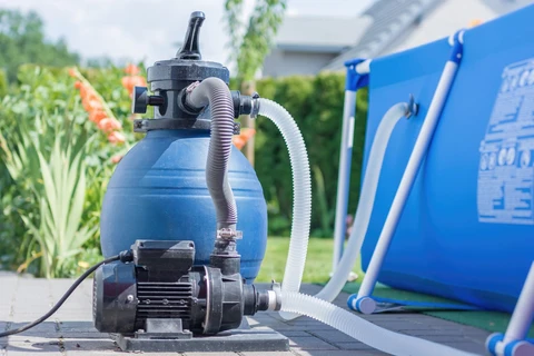 Above-ground pool pump installed beside a pool